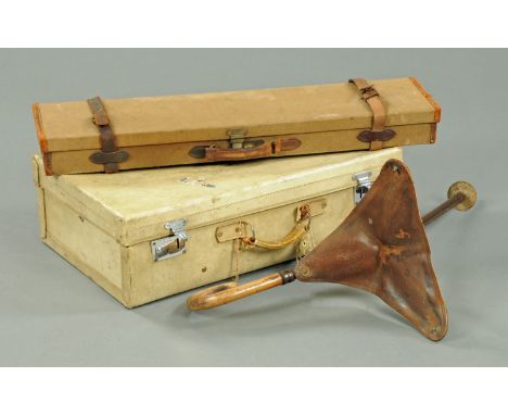 A vellum suitcase, a gun case and shooting stick.  