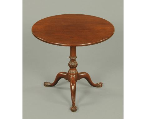 A George III mahogany tripod table, circular, with snap action to turned and carved column and raised on three downswept legs