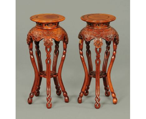 A pair of Chinese hardwood jardiniere stands, each with circular top with pierced frieze beneath and raised on five shaped le