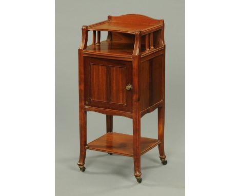 A late 19th century oak Art Nouveau bedside cabinet, with rear upstand, open shelf, panelled cupboard door with further shelf