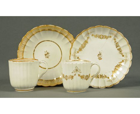 Two Worcester fluted cups and saucers, gilt enriched on white ground.
