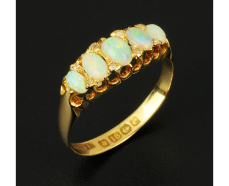 An 18 ct gold opal and diamond ring, size P. CONDITION REPORT: Weight 2.8 grams.  The opals appear to be in generally good co