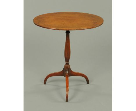 A George III mahogany tripod occasional table, with oval top with snap action to turned centre column with three downswept le