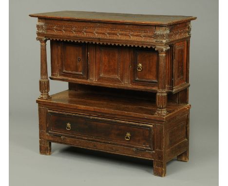 A 19th century oak side cabinet, with carving, with recessed panelled cupboards, shelf and drawer to base.  Width 121 cm. 