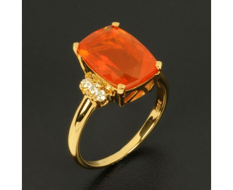 An 18 ct yellow gold fire opal and diamond ring, opal weight approximately 6.75 carats, size O/P (see illustration). CONDITIO