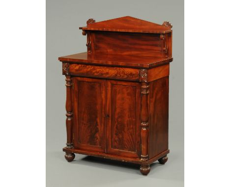 An early Victorian mahogany chiffonier, with triangular pediment and shelf, single drawer, pair of panelled cupboard doors an