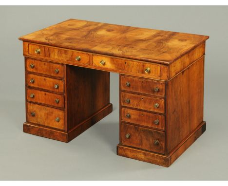 A Regency walnut veneered pedestal desk, with well figured top, two frieze drawers and four further drawers to each pedestal 