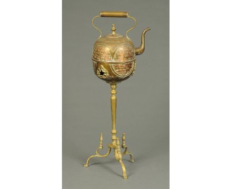 An Eastern brass and copper kettle, raised on a tripod stand.