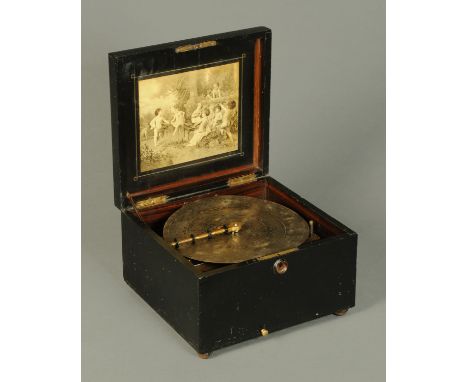 A Victorian polyphon, in ebonised case, complete with 25 discs.  Case width 34 cm, disc diameter 28 cm (11 inches). 