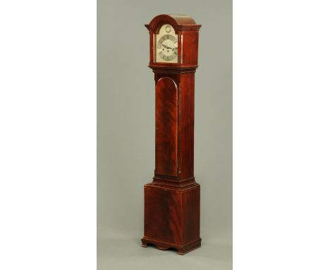 An Edwardian mahogany three-train Grandmother clock, with long arched trunk door, the base raised on bracket feet.  Height 16