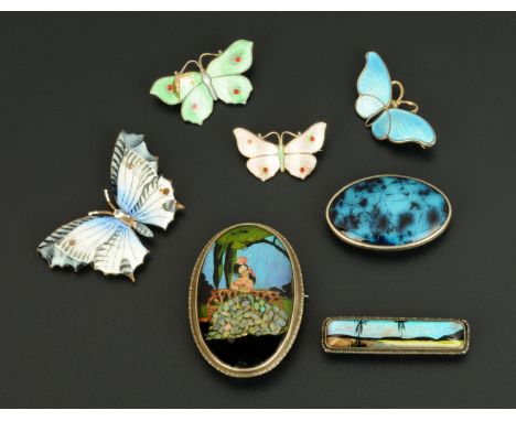 Four enamelled butterfly brooches, and three other enamelled brooches.   CONDITION REPORT: The larger of the oval brooches is