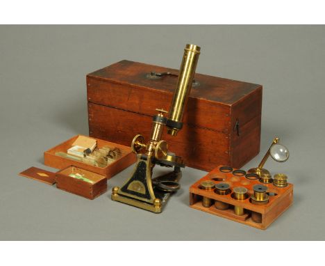A late Victorian microscope, by R. & J. Beck, London, No. 7712, complete with a series of lenses and accessories and in mahog