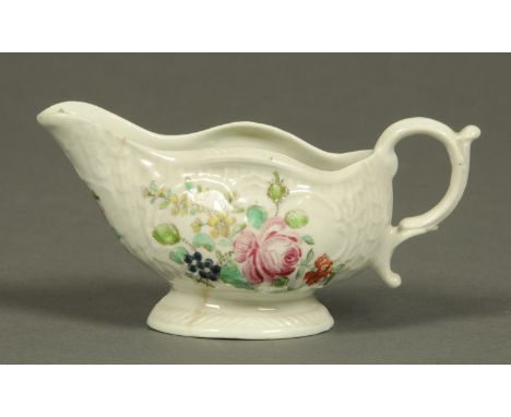 A Worcester silver shaped sauce boat, polychrome, decorated with flowers, circa 1760.  Length 13.5 cm (see illustration). 
