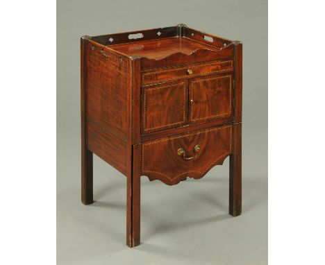 A George III mahogany commode, with recessed top, carrying handle to either side, fitted with a drawer, cupboard and furnishe