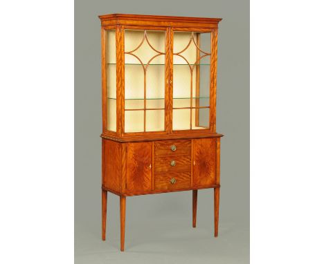 An Edwardian style satinwood display cabinet, with moulded cornice above a pair of glazed doors with wooden astragals and ebo