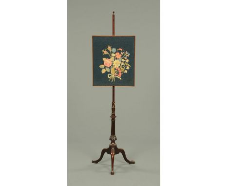 A Victorian mahogany pole screen, with tapestry panel, turned and fluted column and raised on three downswept legs.  