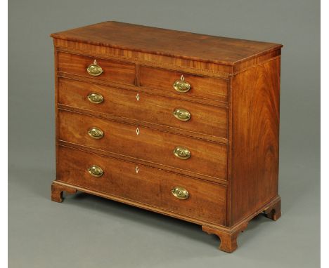 A George III mahogany boxwood strung and crossbanded chest of drawers, with two short and three long graduated drawers with b