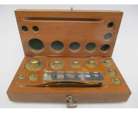 A cased set of Chemist scale weights with tweezers