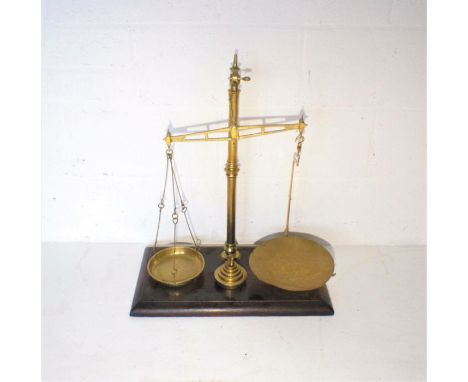 A set of brass scales and weights.