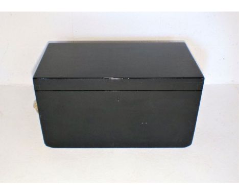 A black painted wooden storage trunk, length 63cm, height 35cm.