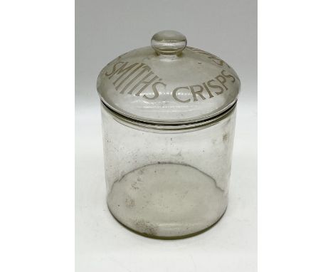 An early 20th century vintage Smiths Crisps glass counter jar, the cylindrical form jar with 'Smiths Crisps' inscribed to cov