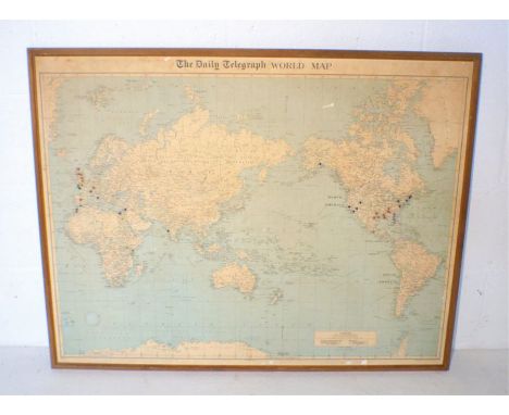 A framed vintage Daily Telegraph world map, 104cm x 81cm.