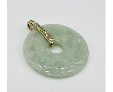 A jade pendant set with 9ct gold