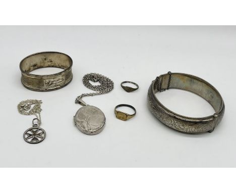 A hallmarked silver bangle, silver locket, gold/silver ring etc.