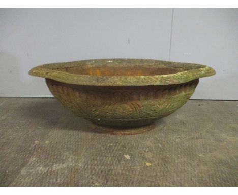 A Victorian shaped cast iron trough with stylised decoration. 