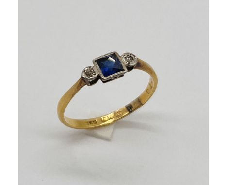 An 18ct gold Art Deco three stone ring set with diamonds and sapphire