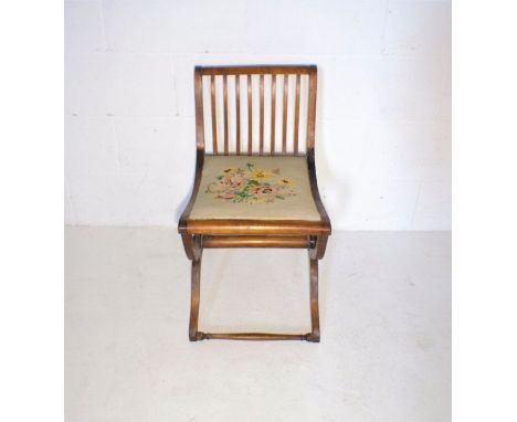 An Edwardian mahogany bedroom chair with cross frame stretcher and tapestry seat.