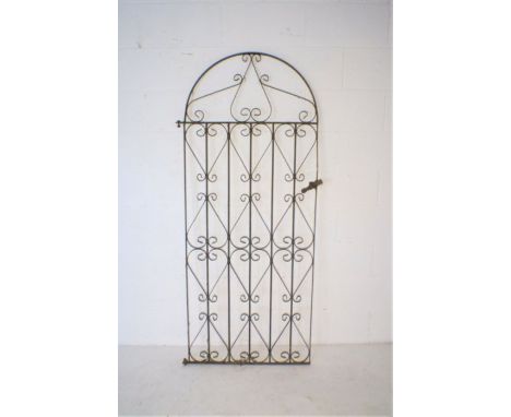A wrought iron garden gate, height 180cm, length 73.5cm.