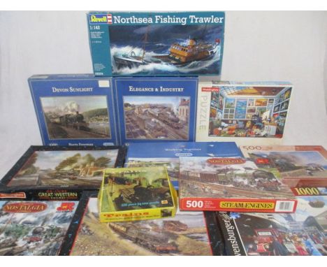 A collection of various jigsaw puzzles mainly relating to trains, along with a Revell Northsea Fishing Trawler model kit (1:4