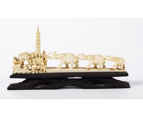Oriental carved ivory elephant scene on a timber stand, 19cm long approx., as inspected, This item cannot be exported