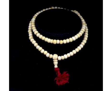 Ivory beaded necklace C.1920s approx 7.7mm bead, 64cm length. This item may not be exported without CITES documentation