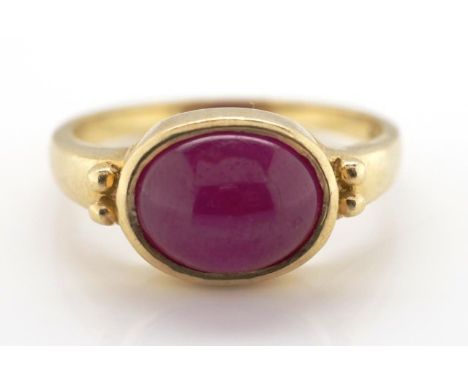 9ct yellow gold and ruby ring with a rub set pinkish red ruby cabochon approx size 7.5mm x 10mm. Marked 9c approx weight 3.28