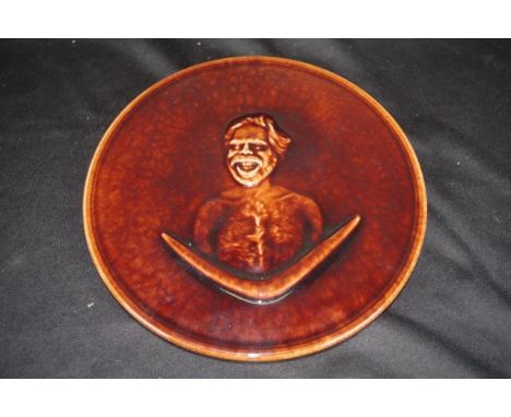 Australian Aborigine theme display plate embossed portrait of an Aboriginal Man, brown glazed, (diameter 20.5cm approx).