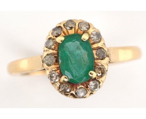 9ct rose gold, emerald and diamond ring unmarked approx 6.2mm x 4.2mm oval cut emerald and a 12x diamond surround. weight 2.5
