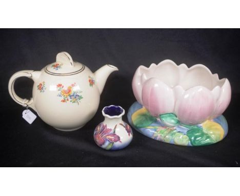 Two various Clarice Cliff ceramic tableware pieces including floral decorated teapot, (height 17cm approx), and a lotus form 