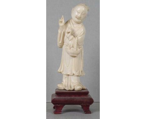 Antique Japanese Meiji period carved ivory okimono depicting a man holding a basket, attached to wooden stand, 13cm high appr