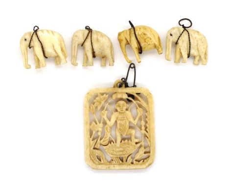 A group of carved Asian ivory circa 1940s with pierced work panel and four elephant charms. This item may not be exported.