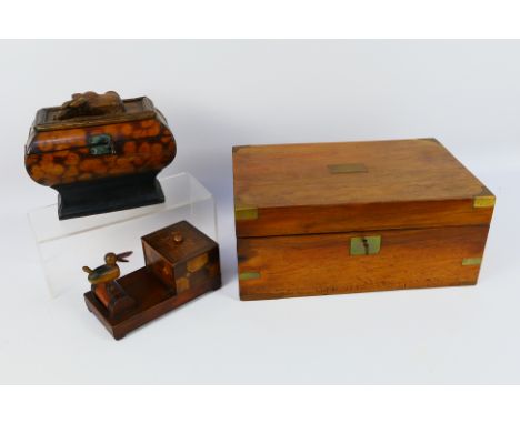 Lot to include a vintage lap desk, novelty table top cigarette dispenser, wooden casket with carved stags head applied to the