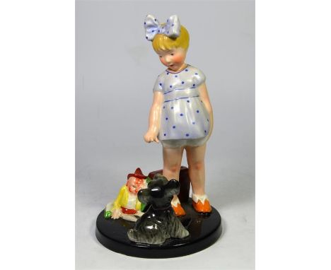 A Goldscheider art deco figure of a young girl playing with a dog. Circa 1920's. Printed and impressed marks. Height 21.5cm.
