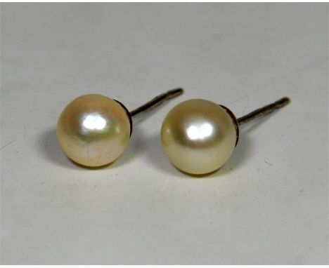 A pair of pearl earrings, apprx. 7mm round cultured pearl earrings with white metal, thought to be silver posts