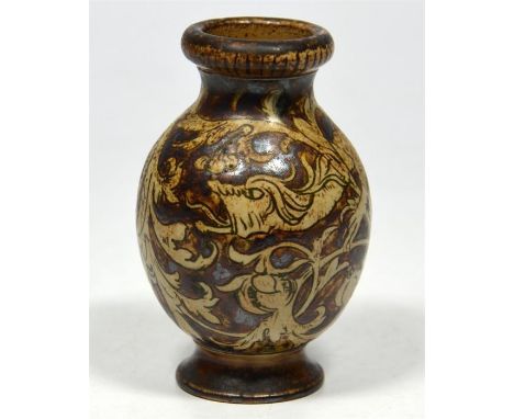 A Martin Brothers vase, decorated with snarling dragons amongst foliage, signed Martin Bros, London, circa 1890. Height 9cm. 