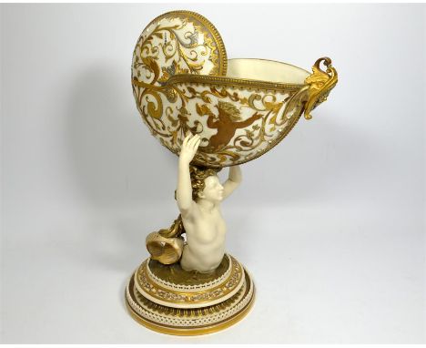A Royal Worcester centre piece, a mermaid holding an involute shell, decorated with raised multiple colour gilding, circa 187