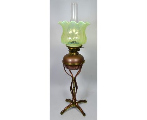 A W.A.S Benson polished brass and copper oil lamp with a vaseline glass shade, circa 1900, marks on base. Total height 73cm. 