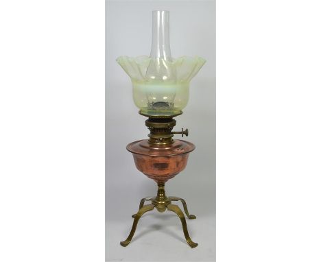 A W.A.S Benson polished brass and copper oil lamp with a vaseline glass shade, named on the burner, circa 1900. Total height 