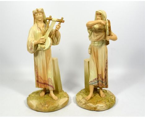 A pair of Royal Worcester Egyptian musicians by James Hadley, circa 1891, model number '1084'. Height of tallest 31cm. (2)