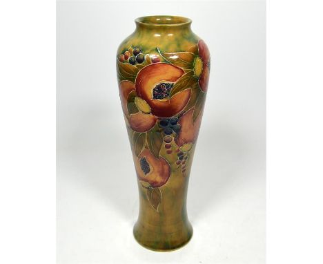 A William Moorcroft 'Pomegranate' vase on an ochre background, circa 1910. Height 30cm.